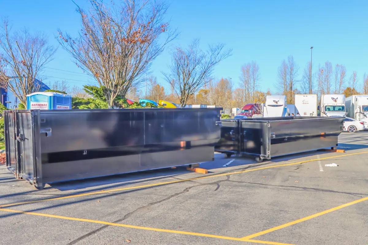 Professional dumpster rental service with roll-off container on residential driveway in Palmer Town